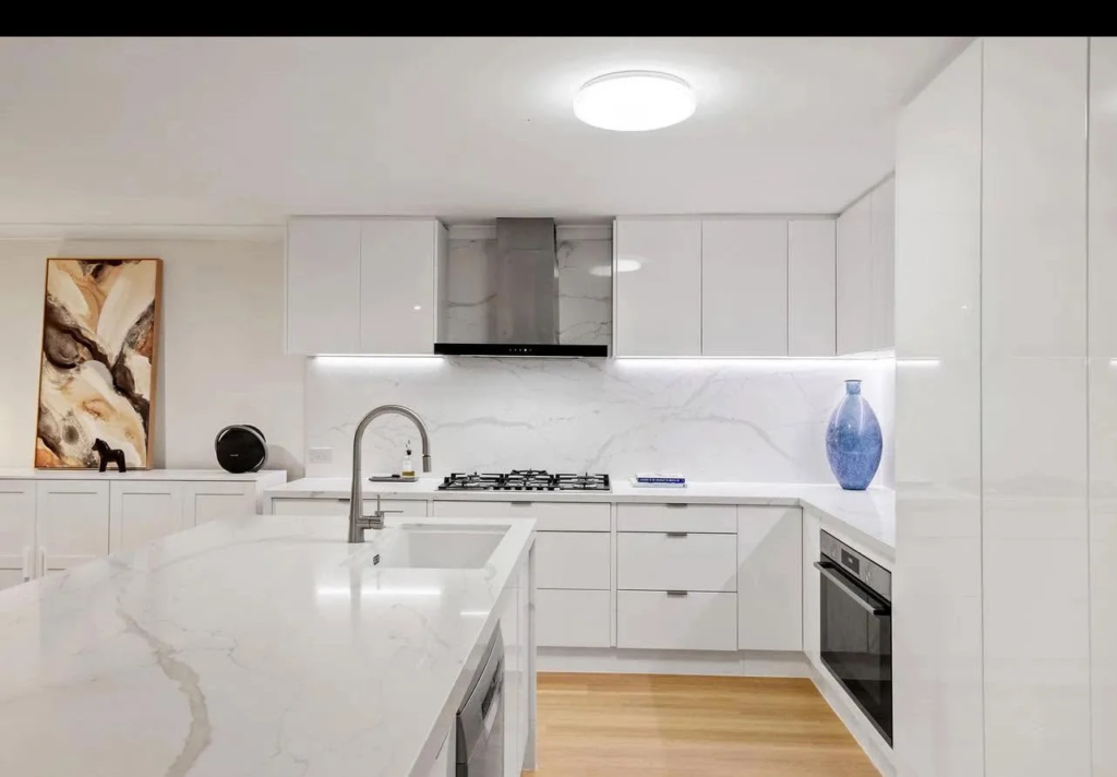 White kitchen & brass-toned tap